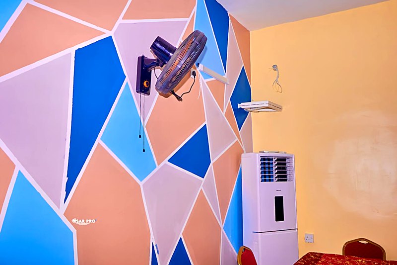 Painted feature wall, wall fan and standing cooler